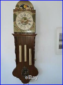 Antique Frisian tail clock with bronze Westminster chime and bridaldress